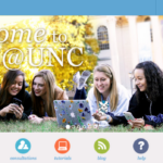 Sakai welcome header of 4 happy students lying on grass in the Quad with a laptop and Sakaiger mascot in hand