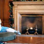 Carolina mascot Rameses reading a book by the fireplace